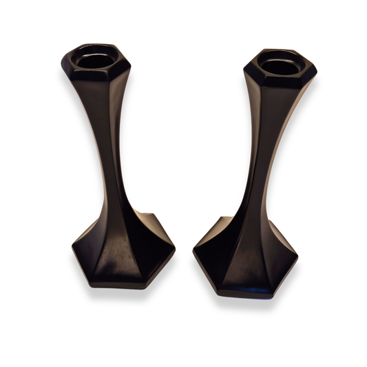 Pair of black candle holders on a white background