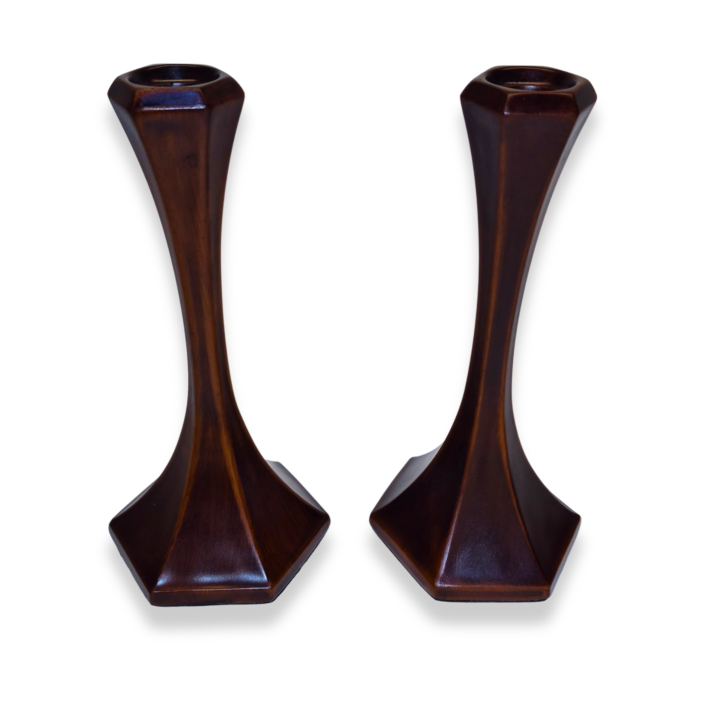 Pair of dark brown candle holders on a white background