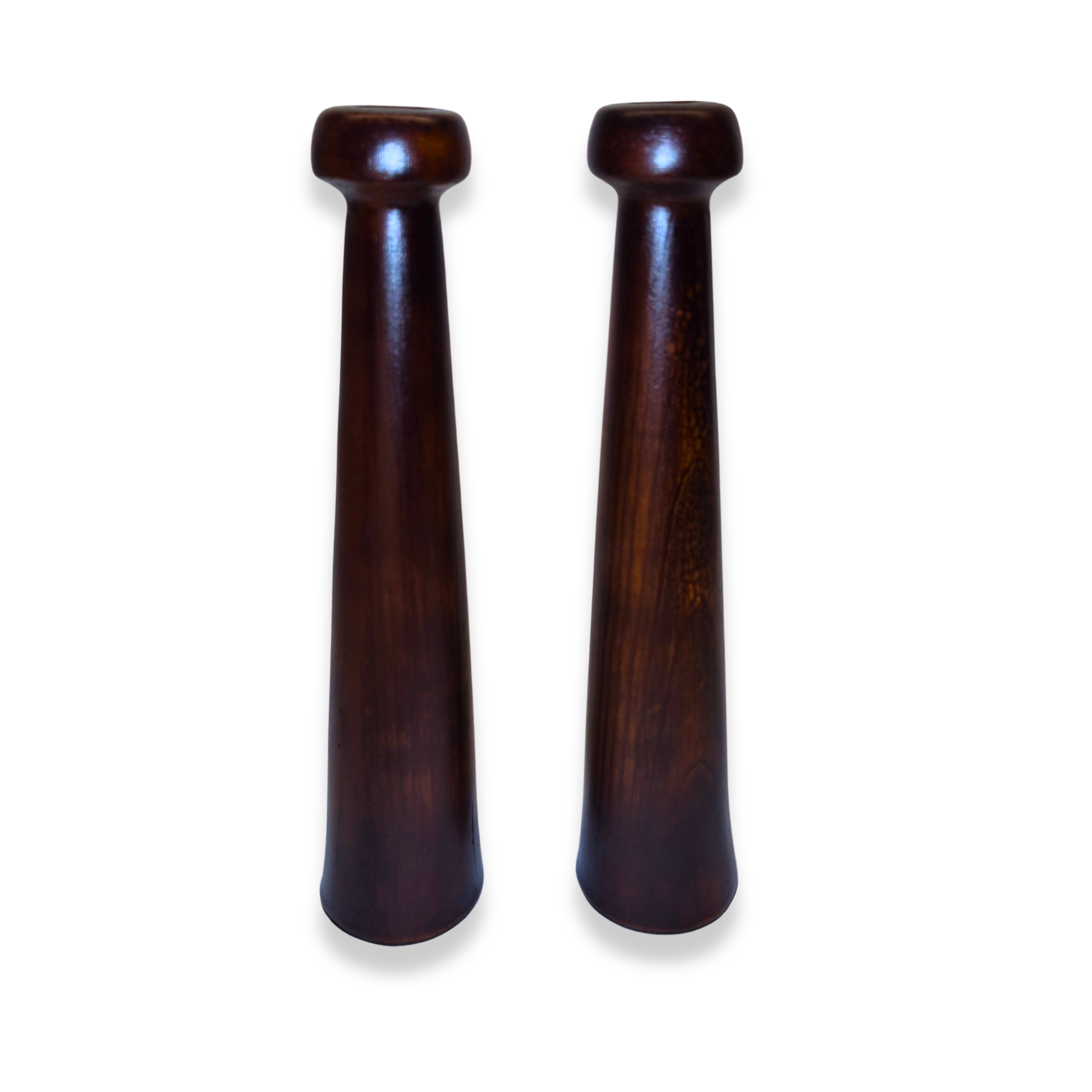 Two wooden salt and pepper shakers on a white background