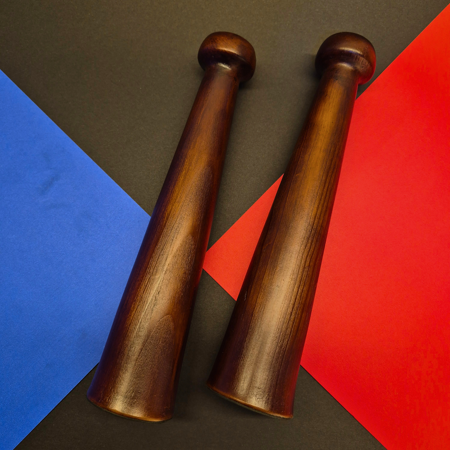Two wooden candel holder on a colorful geometric background