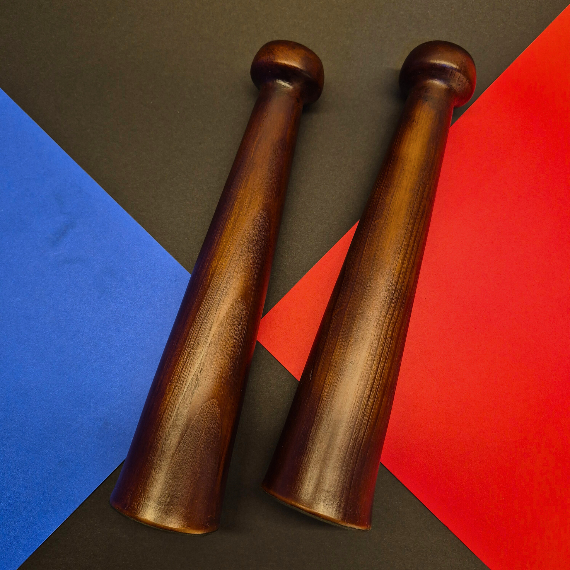 Two wooden candel holder on a colorful geometric background