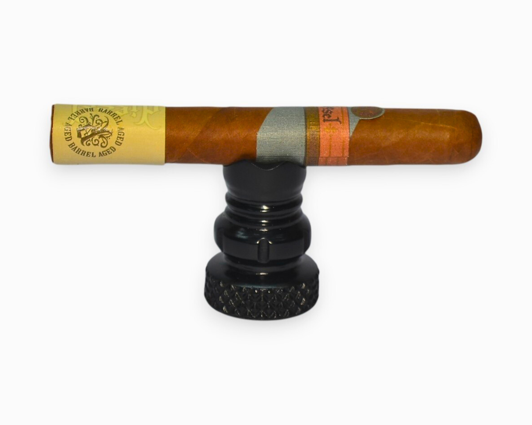 Cigar with a branded wrapper on a black stand against a white background